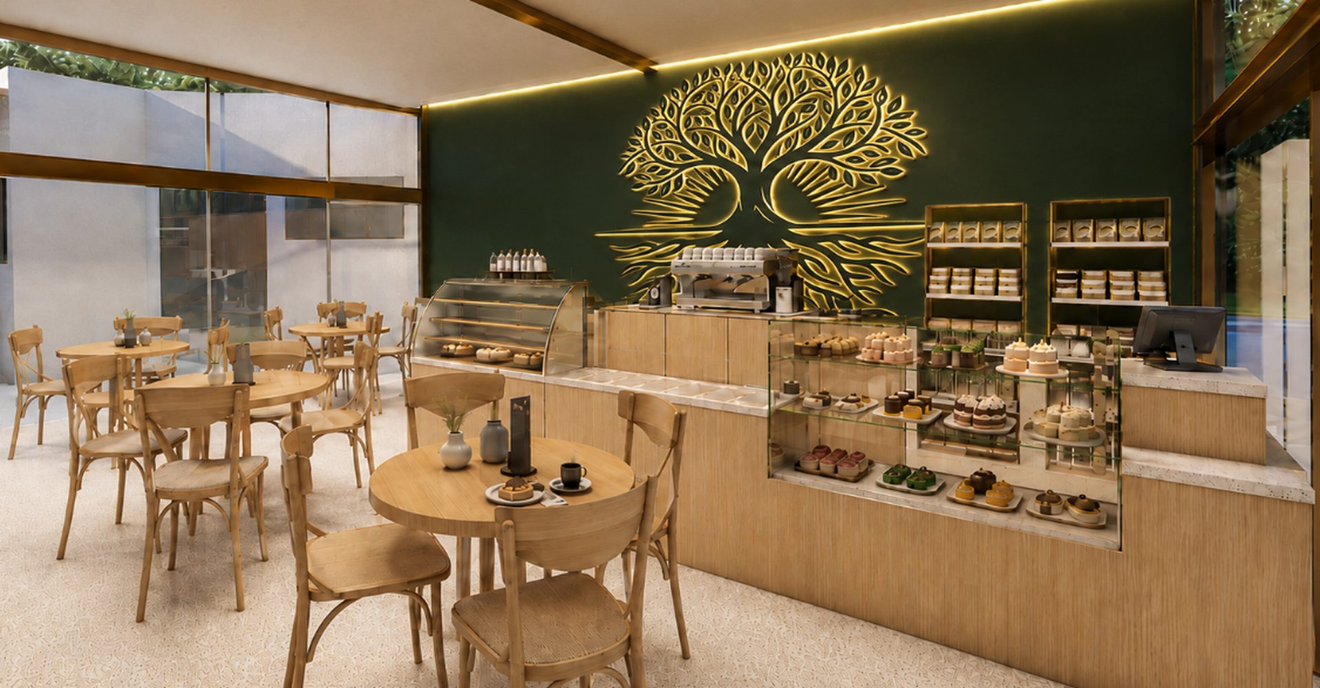 Cafetería de Monteluz con árbol dorado retroiluminado y repostería artesanal