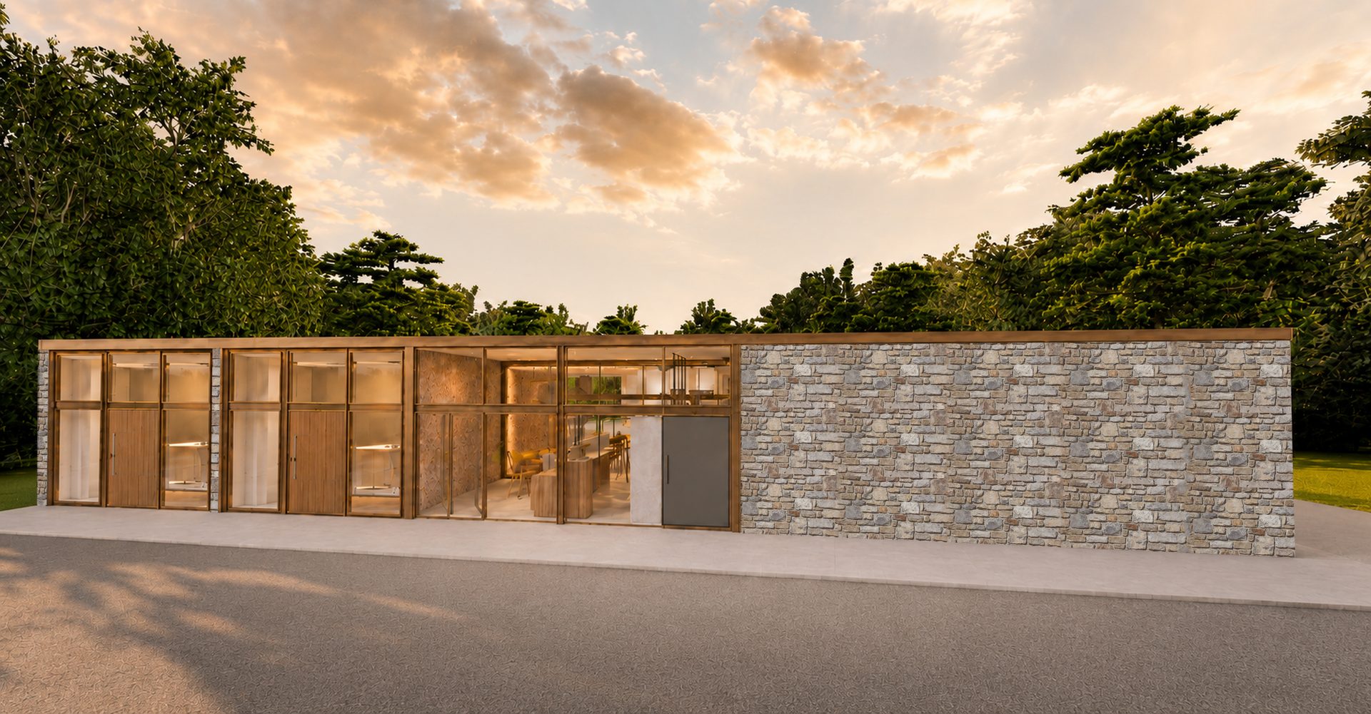 Fachada de acceso de Monteluz: cristal, madera y muro de piedra al atardecer